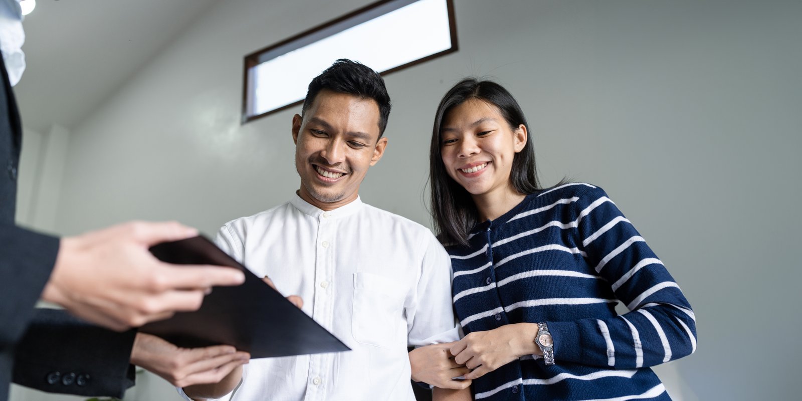 young happy smiling couple read agreement with rea 2023 12 06 16 24 50 utc